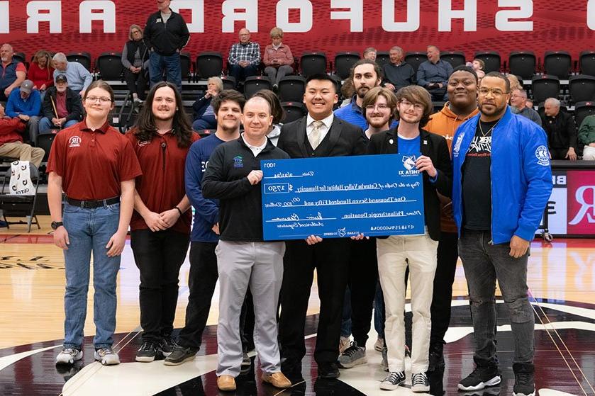 Theta Xi members present check to Habitat for Humanity of Catawba Valley